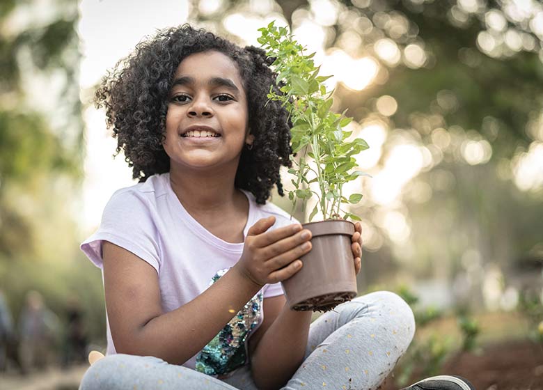 tree planting - girl with potted tree